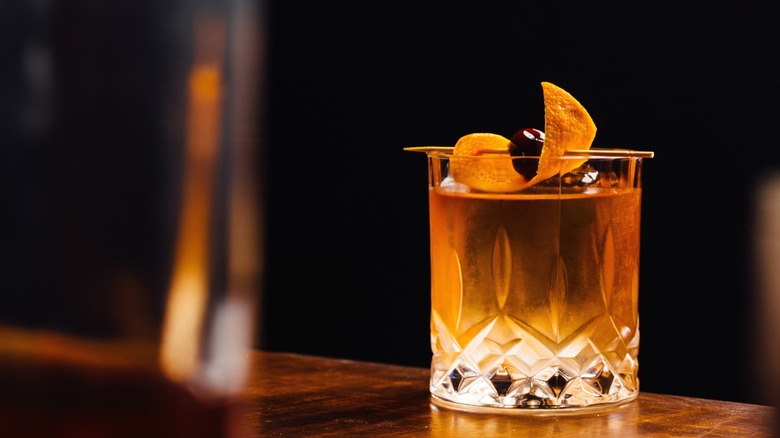 An Old Fashioned cocktail on a bar.