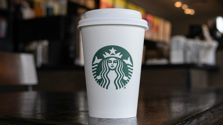 To-go cup of Starbucks coffee in Starbucks cafe