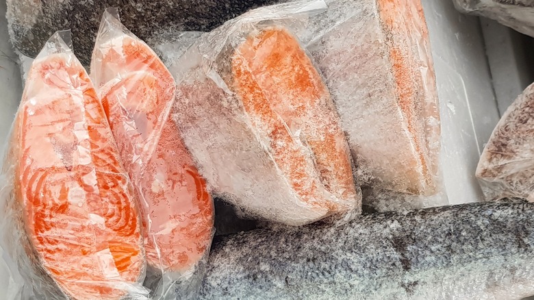 Frozen packaged fish in a freezer.