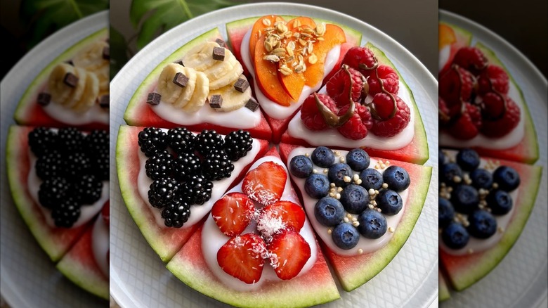 Watermelon pizza with multiple fruit toppings.