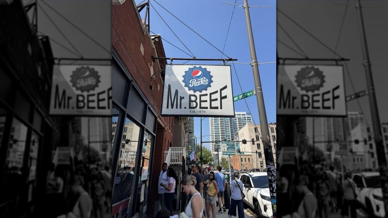 The Mr. Beef sign, with a long line of people underneath