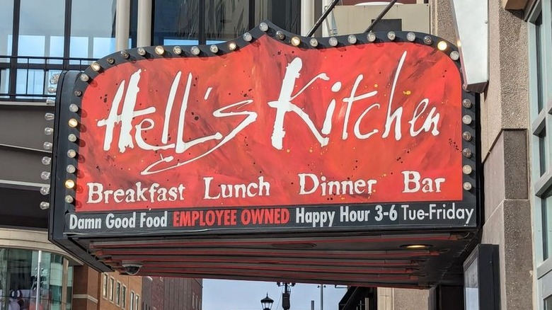 The exterior sign for Hell's Kitchen; red with white lettering with a marquis light border