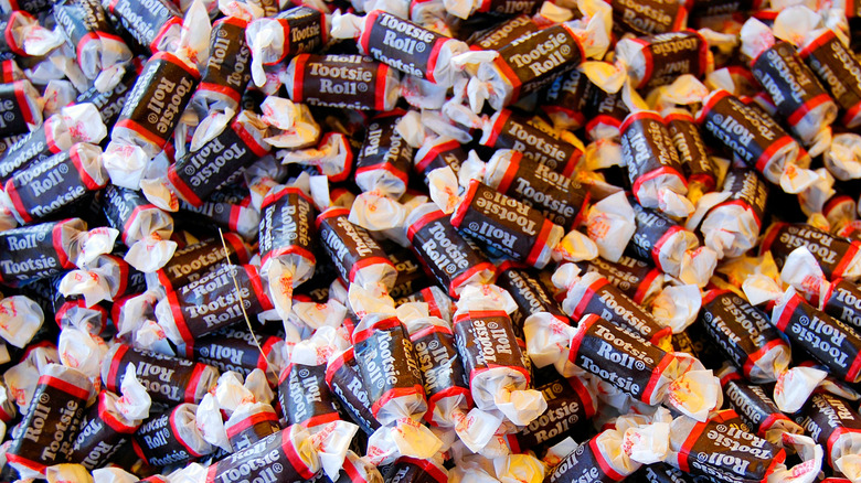 A pile of Tootsie Rolls in wrappers