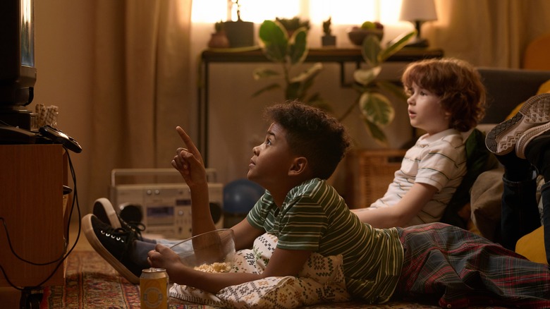 Two kids watching tv in retro setting