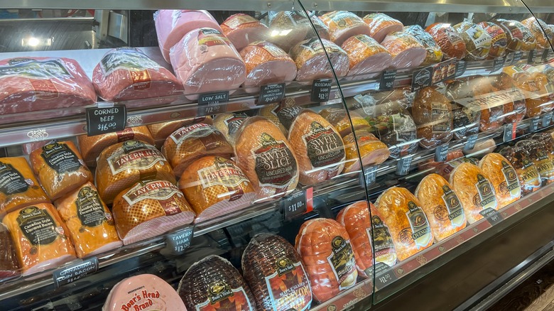 Deli meat in a glass display case.
