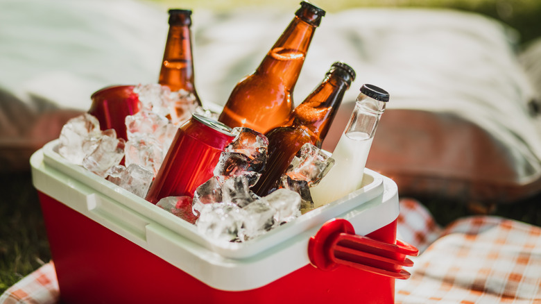 Red cooler overflowing with ice and beverages