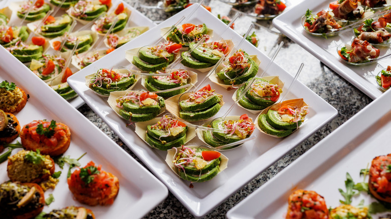 Platters of hors d'oeuvres sitting on a table