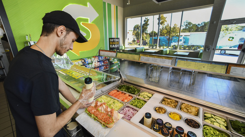 man making subway sandwich