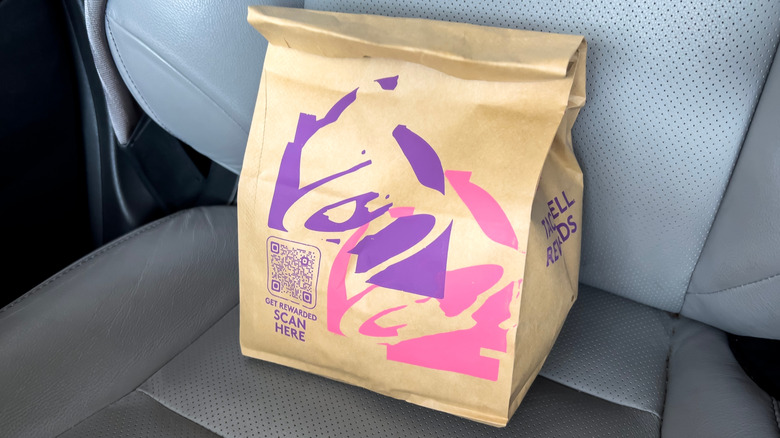Bag of Taco Bell food on a car seat