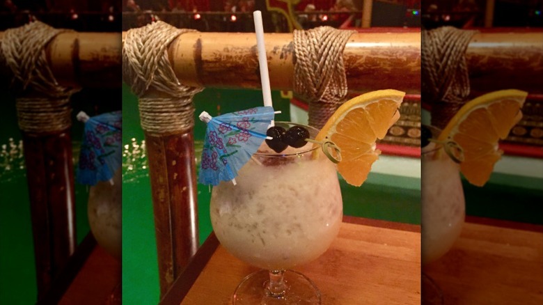 A tropical drink at the Tonga Room, with lagoon in the background.