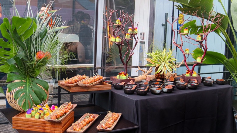 assorted foods laid out on tables inside Abacá