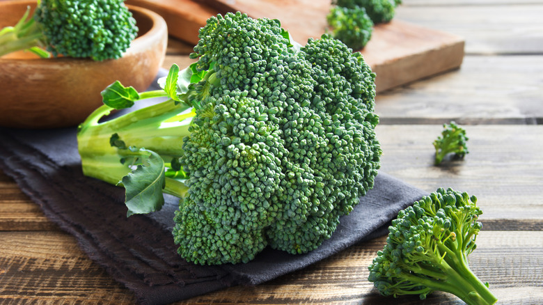 Fresh broccoli florets on a wooden table