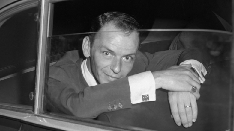 Hollywood singer, Frank Sinatra, looks quizically into a press camera shortly after a conference with the Rome press where he denied reports that he had been booed and cat-called off the stage of a Naples theater.