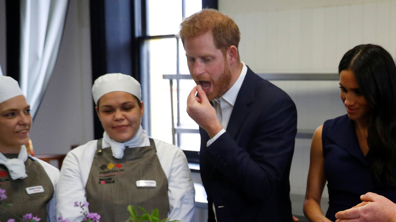 Prince Harry, Duke of Sussex and Meghan, Duchess of Sussex eat traditional native Australian ingredients during a visit to Mission Australia social enterprise restaurant Charcoal Lane, Fitzroy on October 18, 2018 in Melbourne, Australia.