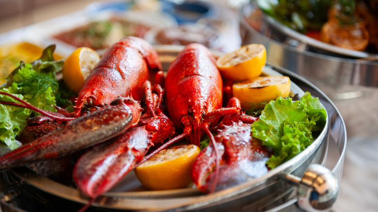 Lobster dish with fresh lobster, lemon, and greens.