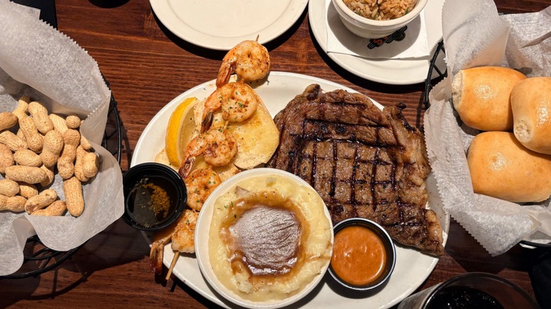 Steak, shrimp, mashed potatoes, rolls, and peanuts from Texas Roadhouse