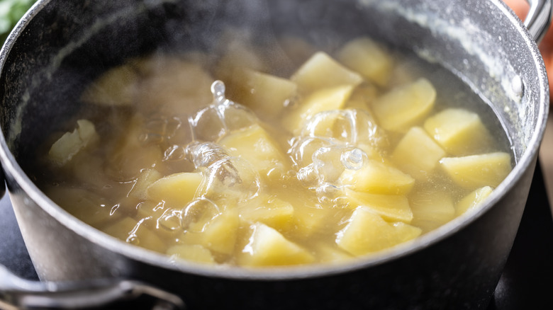 Chopped potatoes boiling in a pot