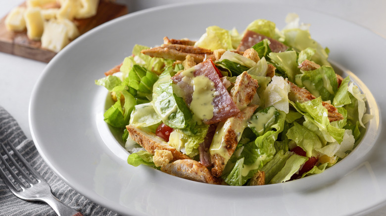 Caesar salad in a large bowl at a restaurant.