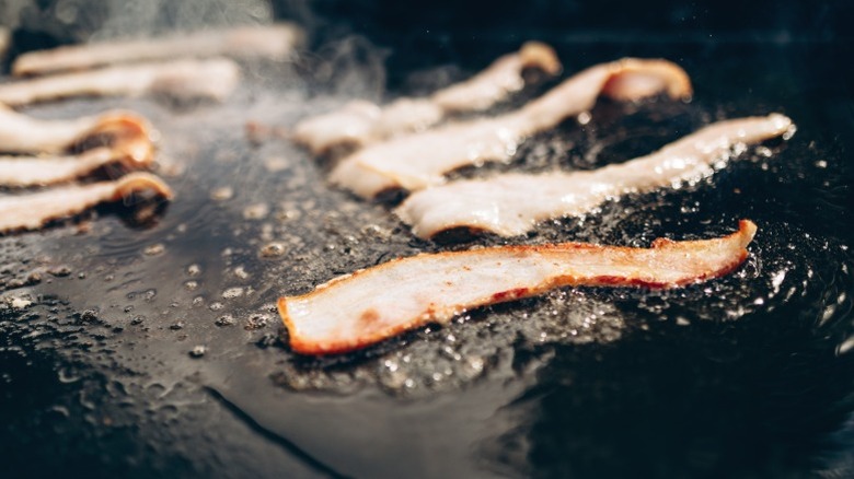 Bacon frying in a skillet.