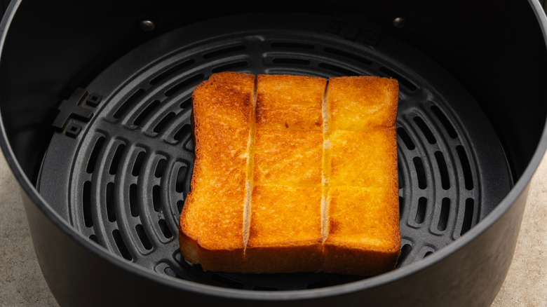 A slice of golden toasted bread in an air fryer