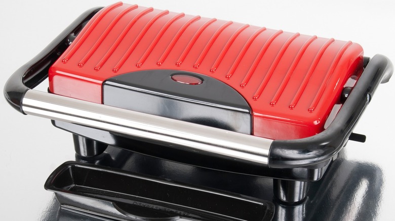 Red, black, and silver panini machine