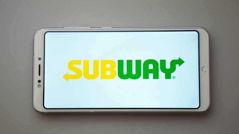 the subway logo displayed on a sideways cell phone