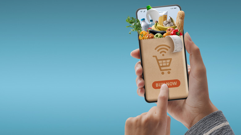 Phone with grocery app on a light blue background