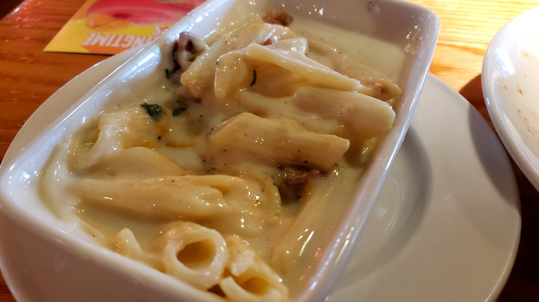 Penne pasta with white sauce in square dish