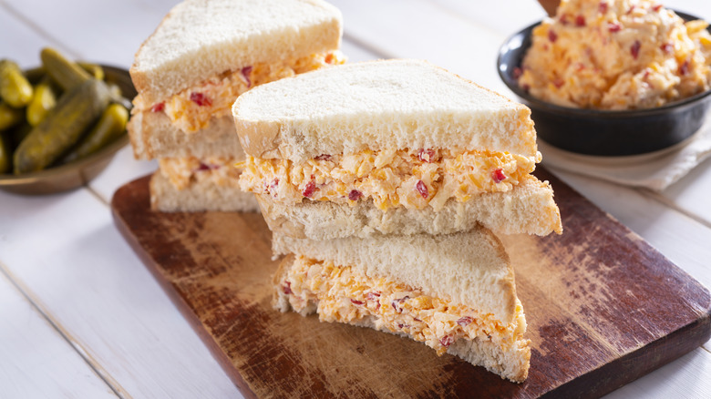 pimento cheese sandwiches on bread board
