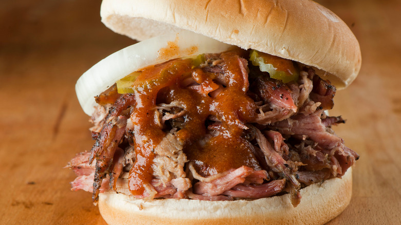 chopped brisket sandwich with sauce on bun