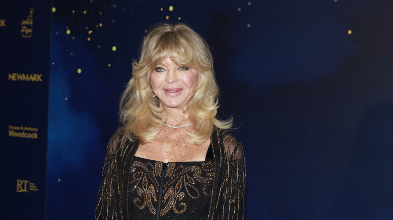 Goldie Hawn at an event smiling at the camera.