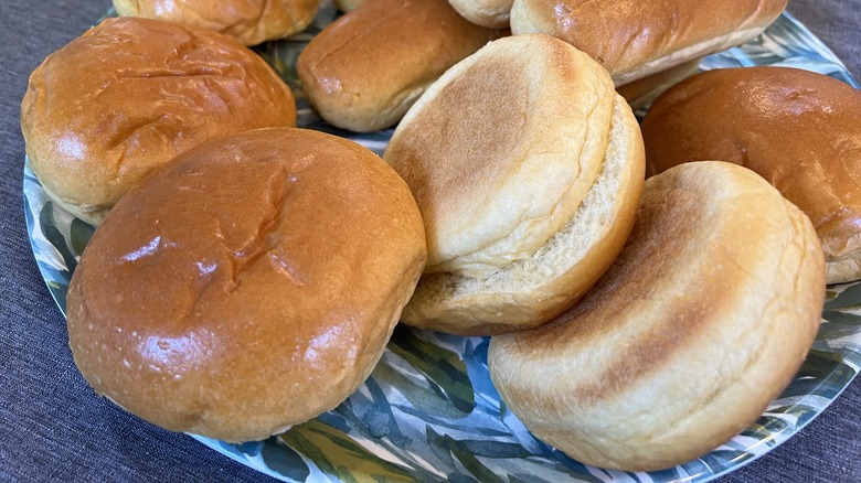 A plate with several hamburger buns stacked on it