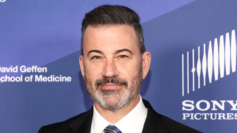 Jimmy Kimmel wearing a suit and smiling