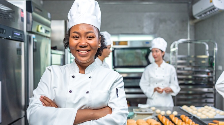 Bakers wearing tall white chef hats.