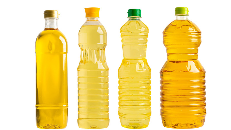 Different types of cooking oil against a white background