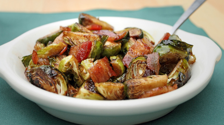 White dish with caramelized brussels sprouts and bacon