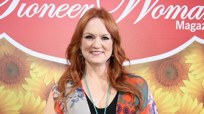 Ree Drummond smiling in front of a press backdrop