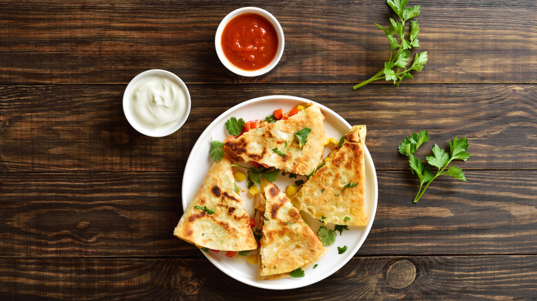 vegetable quesadilla served with sour cream and salsa