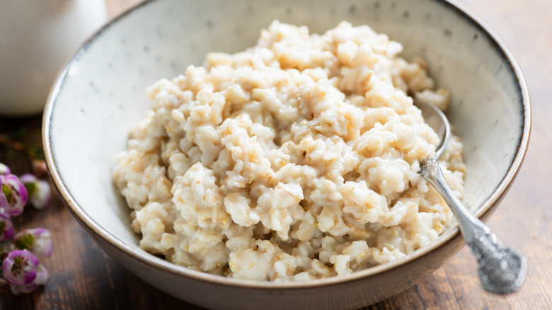 A bowl full of oatmeal with a spoon in it