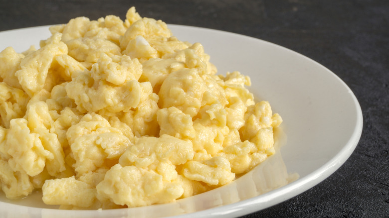 Fluffy scrambled eggs on a white plate