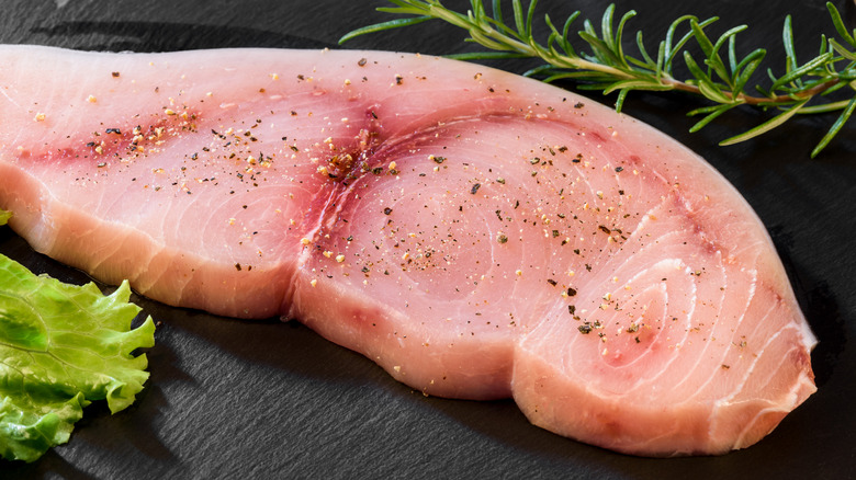 A raw swordfish filet sitting on a counter.