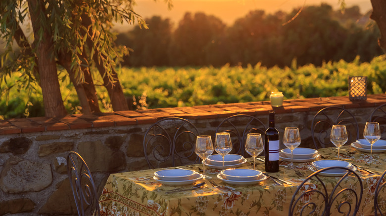 Table set for meal with Tuscan landscape in background