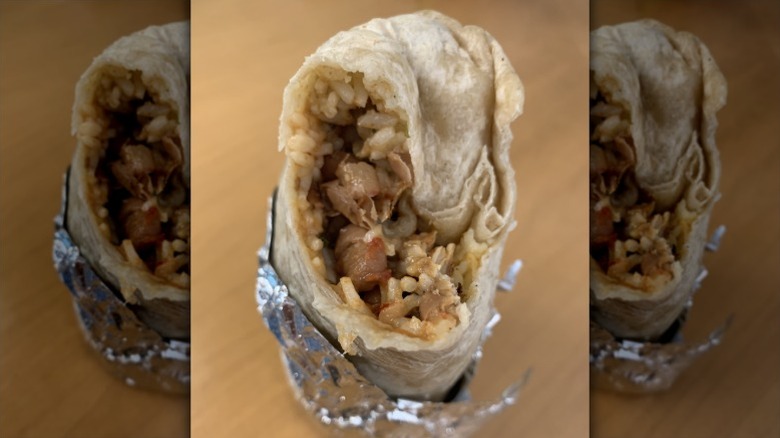 foil-wrapped mission-style burrito with meat and rice