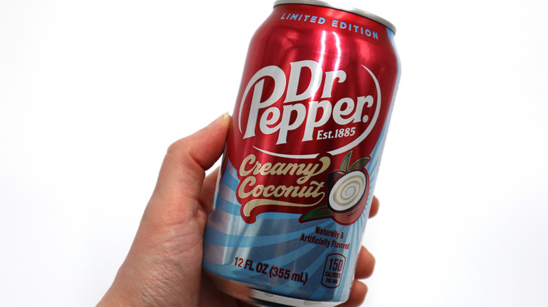 Hand holding a can of Dr Pepper Creamy Coconut