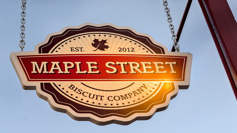 A Maple Street Biscuit Company hanging sign outside