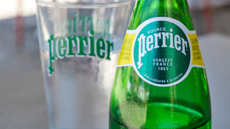 Close up of bottle of perrier and perrier glass