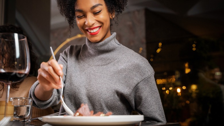 Woman eating at a fine dining restaurant