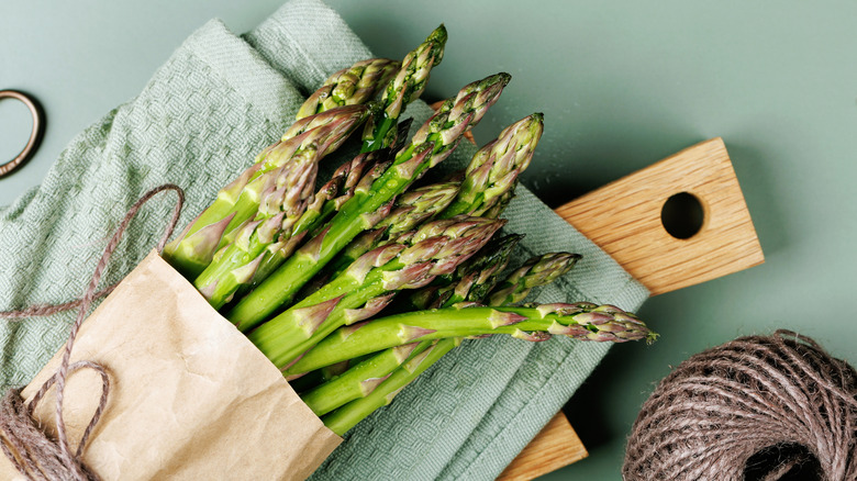 asparagus resting on a cutting board covered by a towel