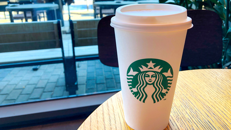 A white Starbucks cup on a table