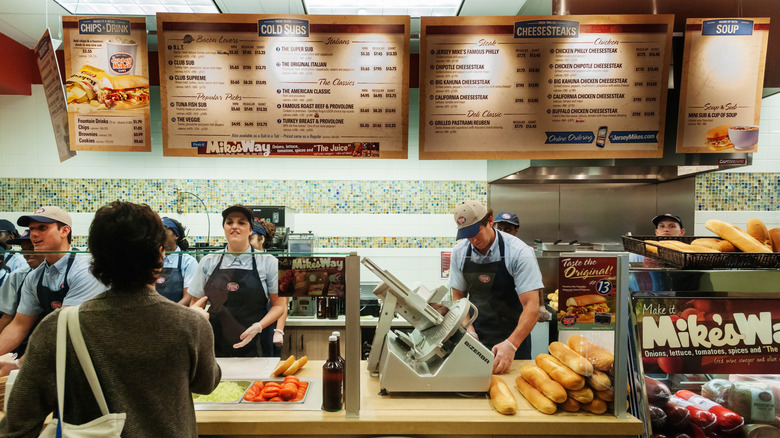 Interior of Jersey Mike's with customer communicating with workers